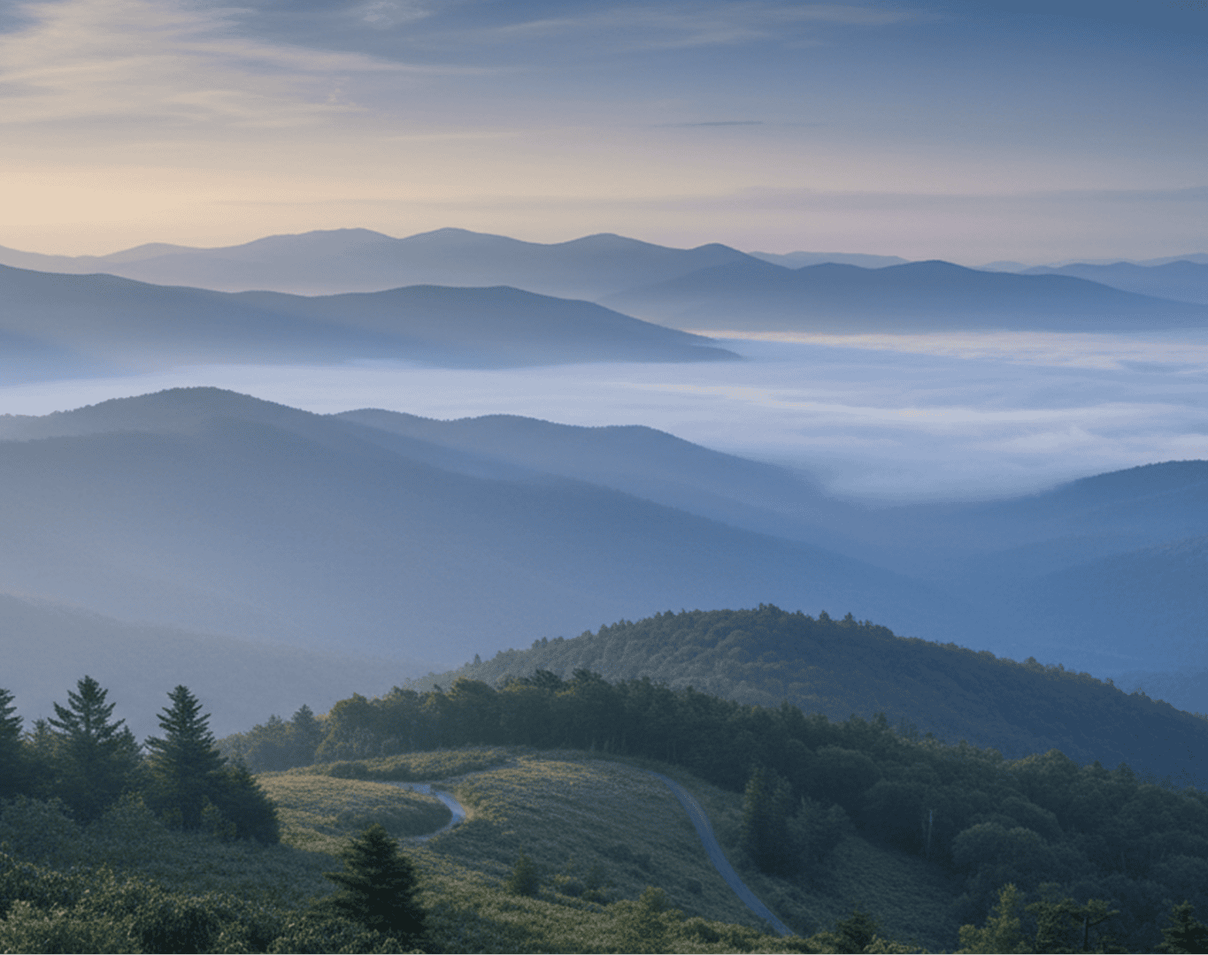Mountain landscape with misty valleys at sunrise.