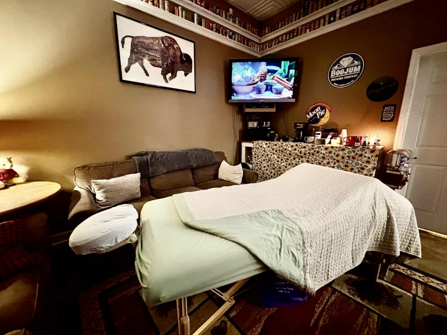 Massage room with TV and decorations displayed.