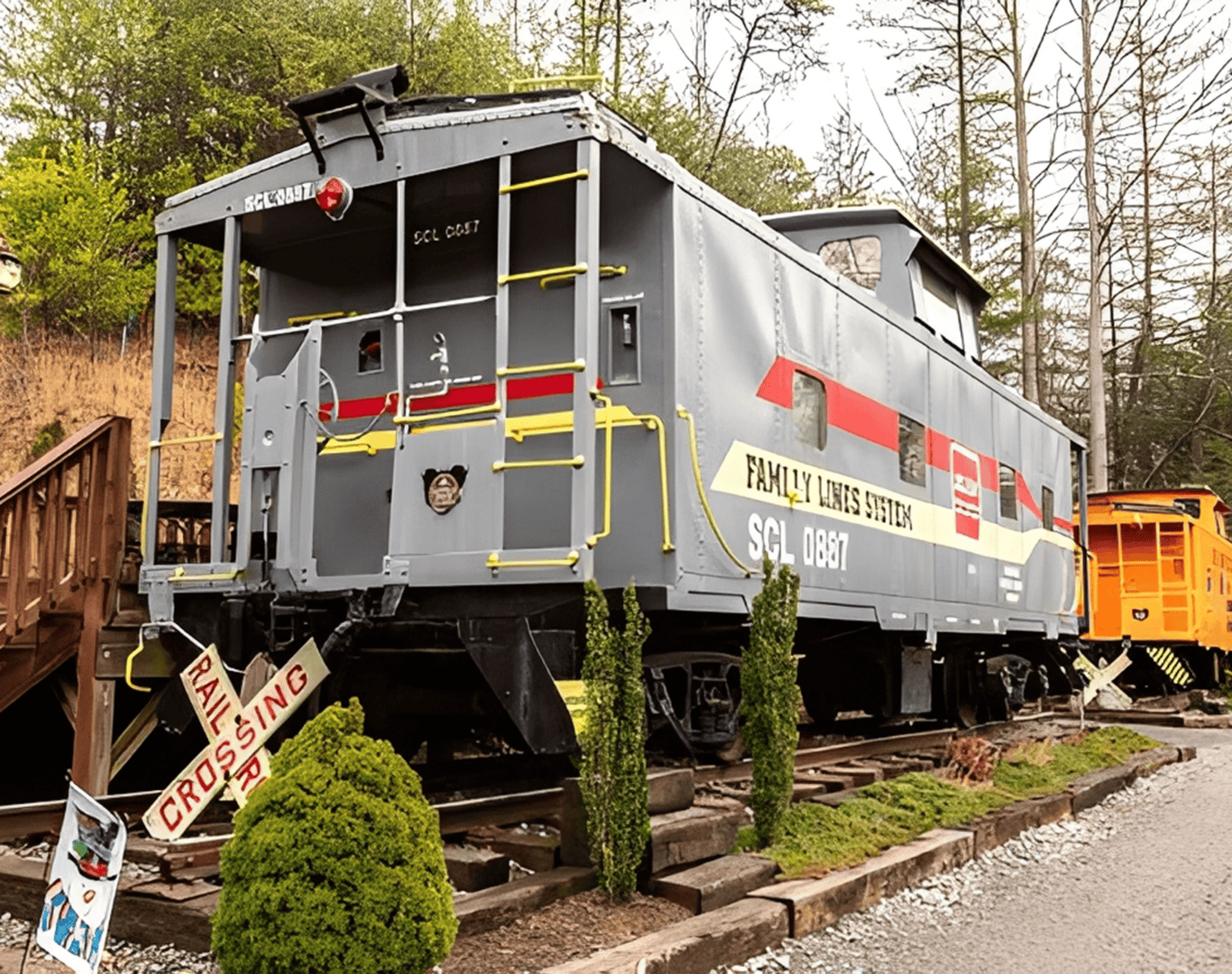 Gray vintage train caboose with red details.