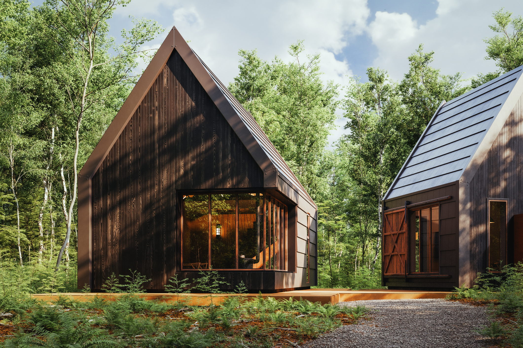 Modern cabins surrounded by lush green forest.
