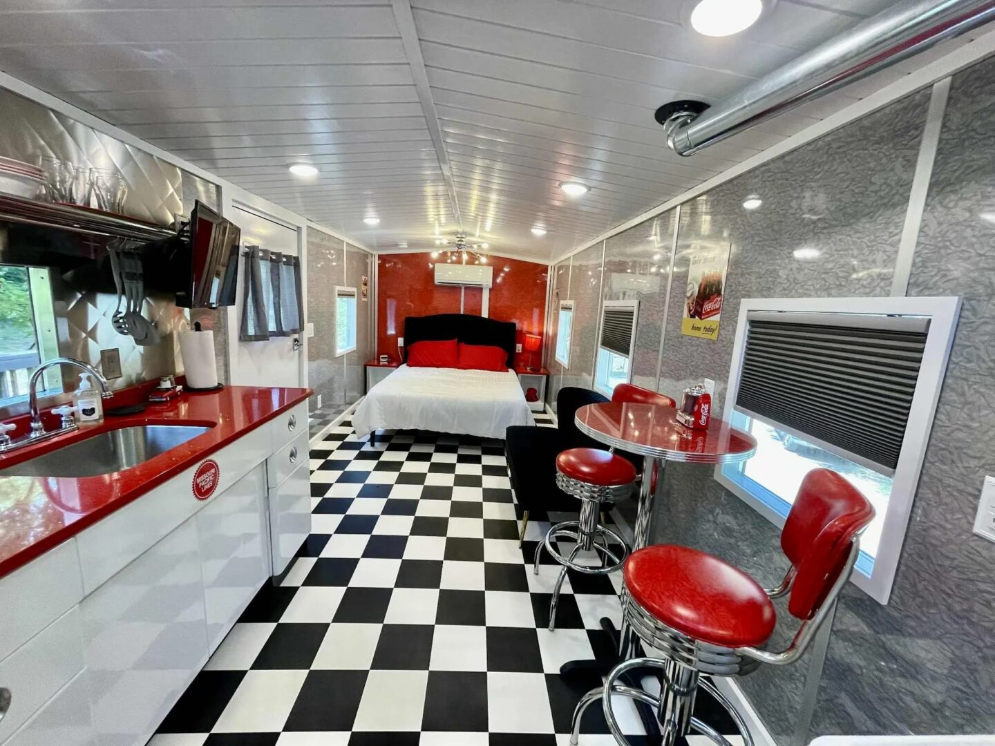 Retro diner-themed trailer interior with checkered floor.