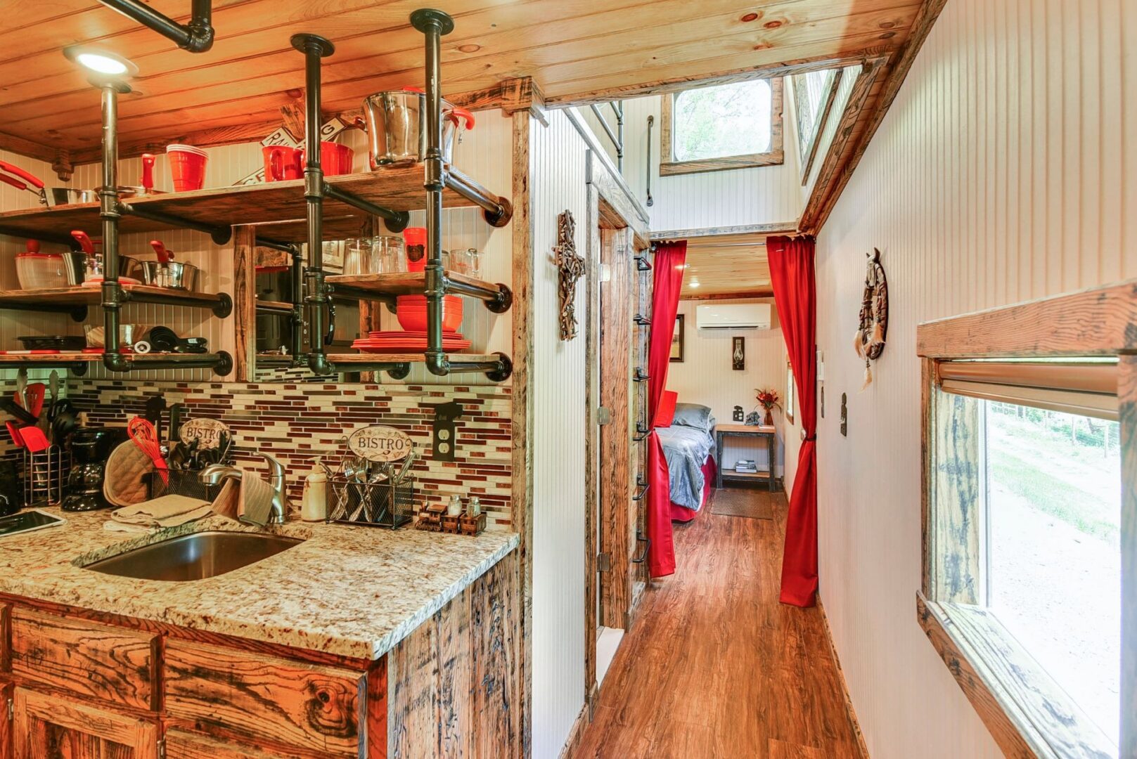 Rustic kitchen with wooden cabinets and shelving.