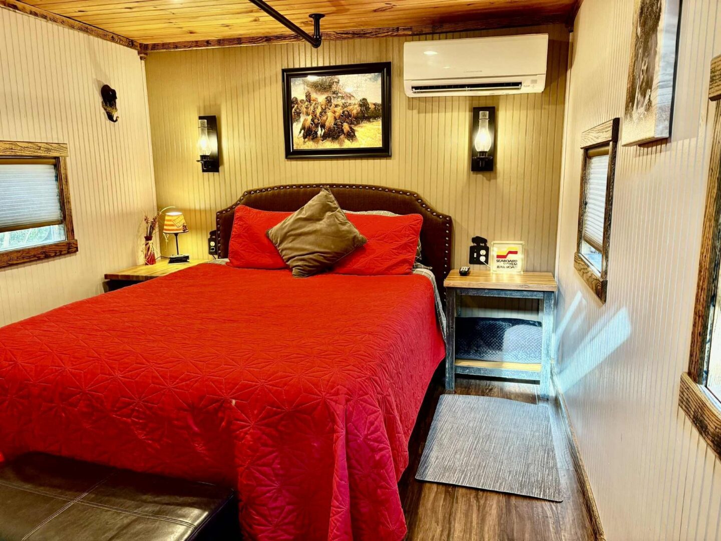 Cozy bedroom with red bedding and decor.