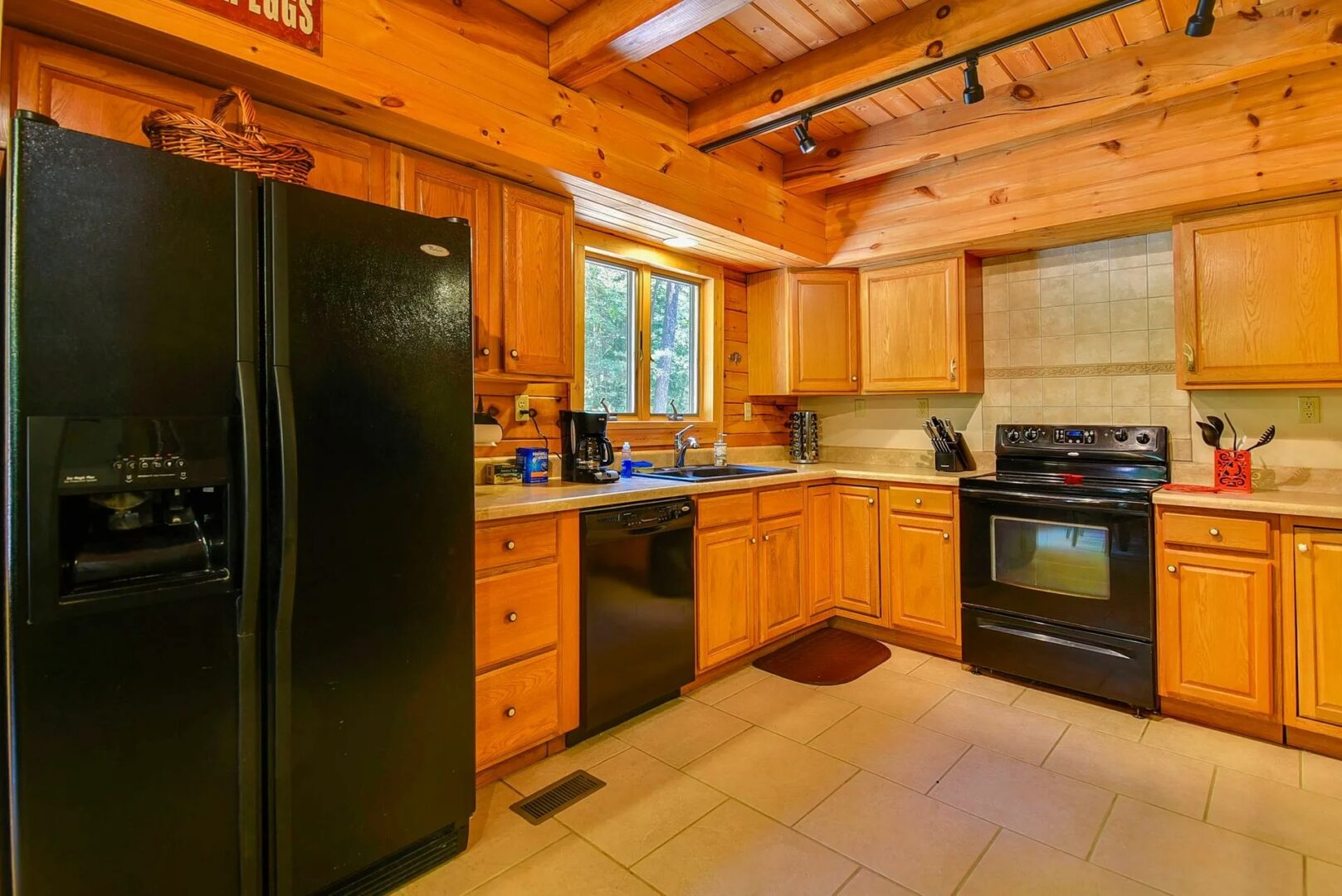 Rustic kitchen with wooden cabinets and appliances.