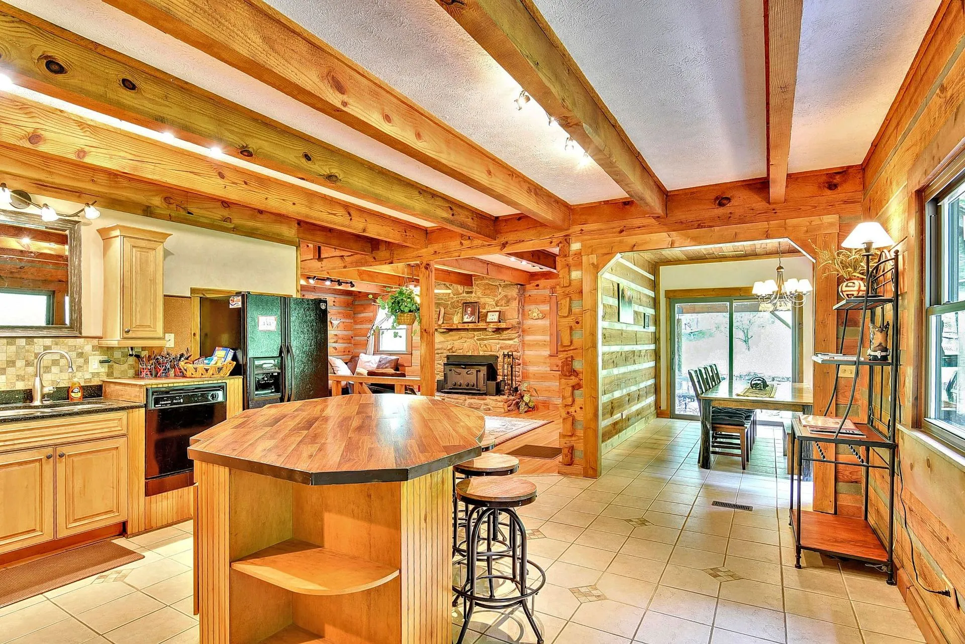 Rustic kitchen with wooden beams and island.