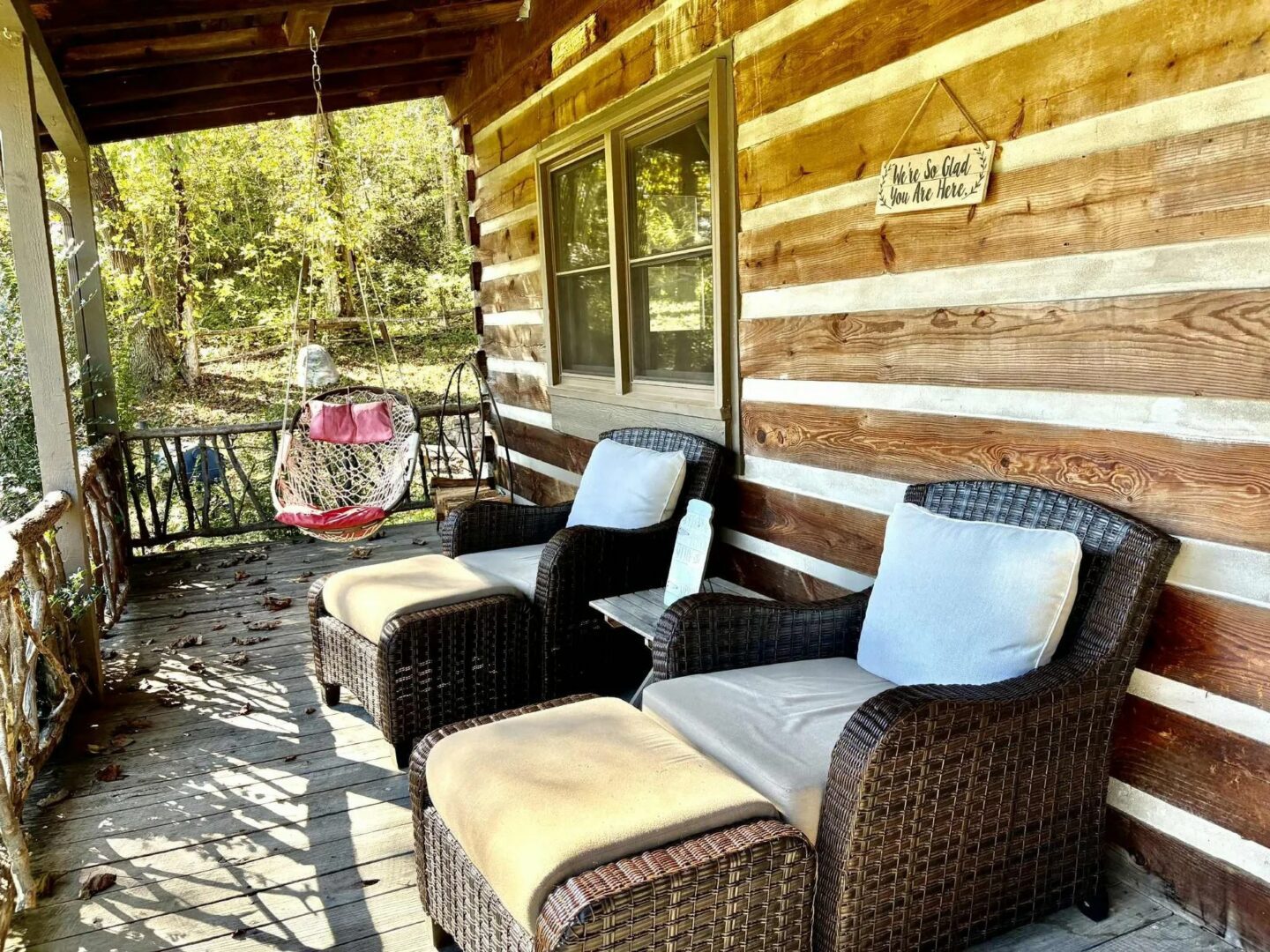 Log cabin porch with wicker chairs.