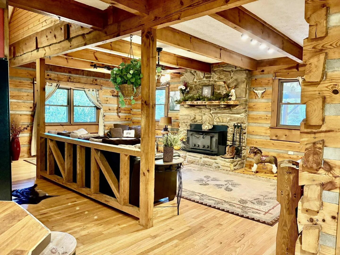Rustic living room with wooden beams and fireplace.