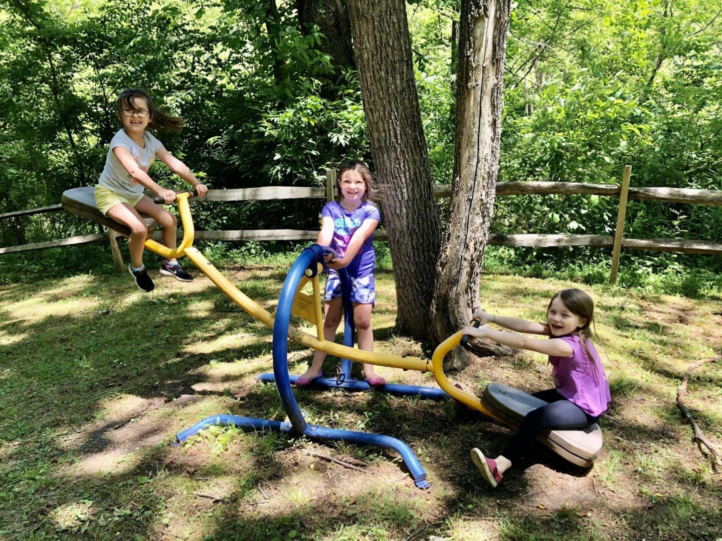Children playing on a seesaw in park.