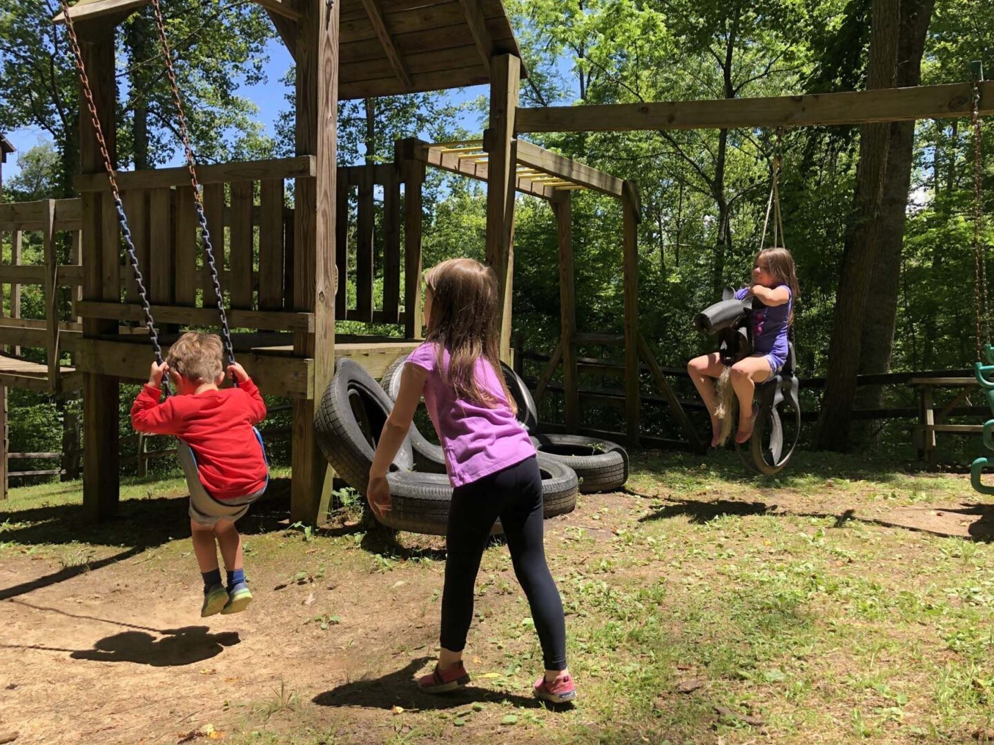 Children playing on swings in playground.