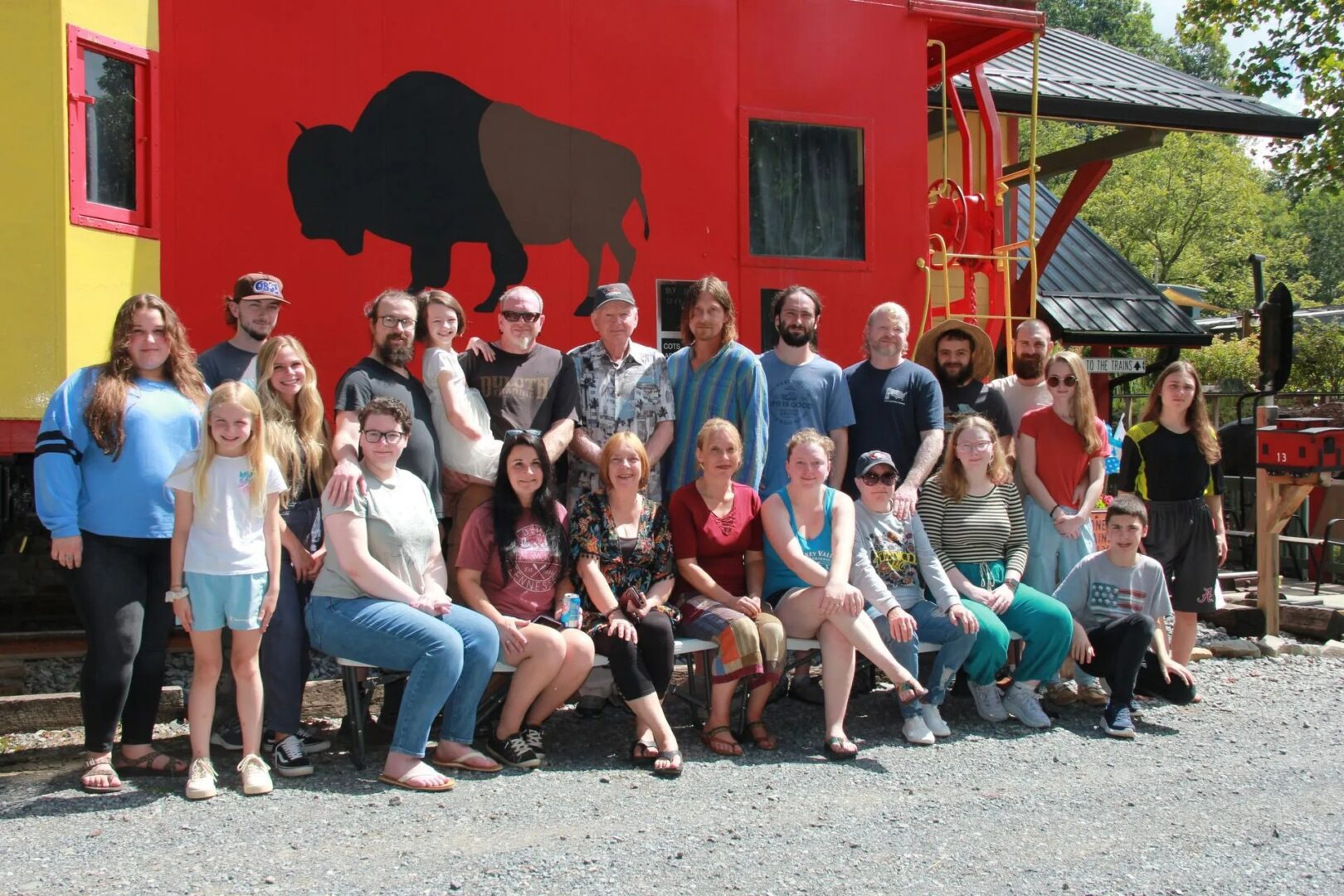 Group photo in front of red train.
