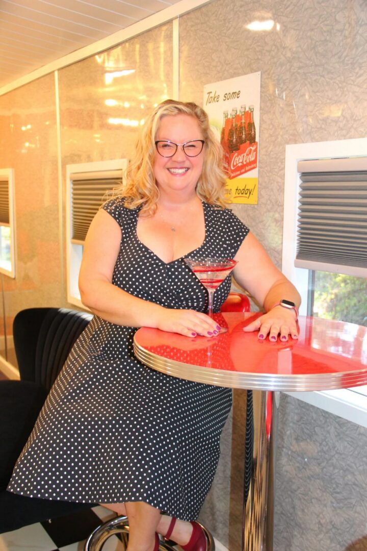 Woman smiling at retro-themed dining table.