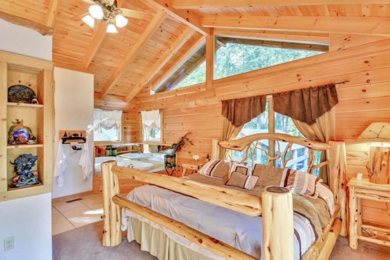 Rustic wooden bedroom with large bed.
