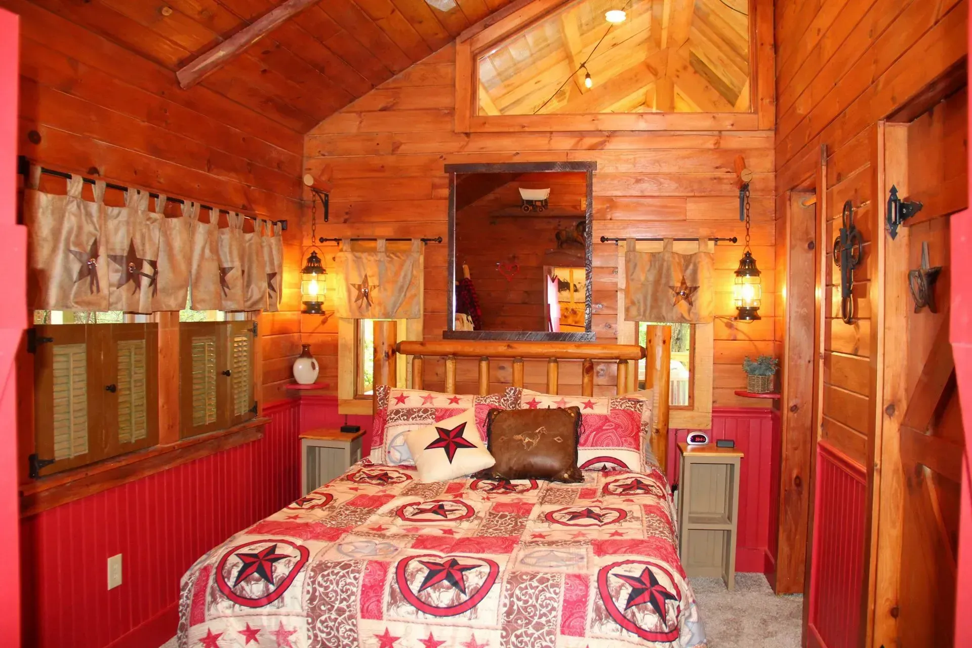 Rustic bedroom with wooden walls and decor.
