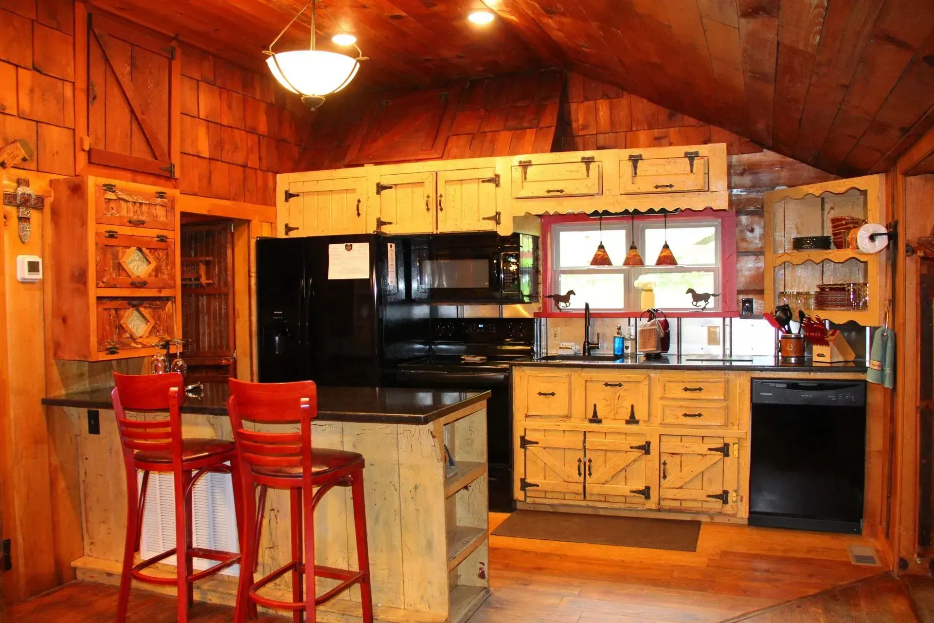 Rustic cabin kitchen with wooden cabinets.