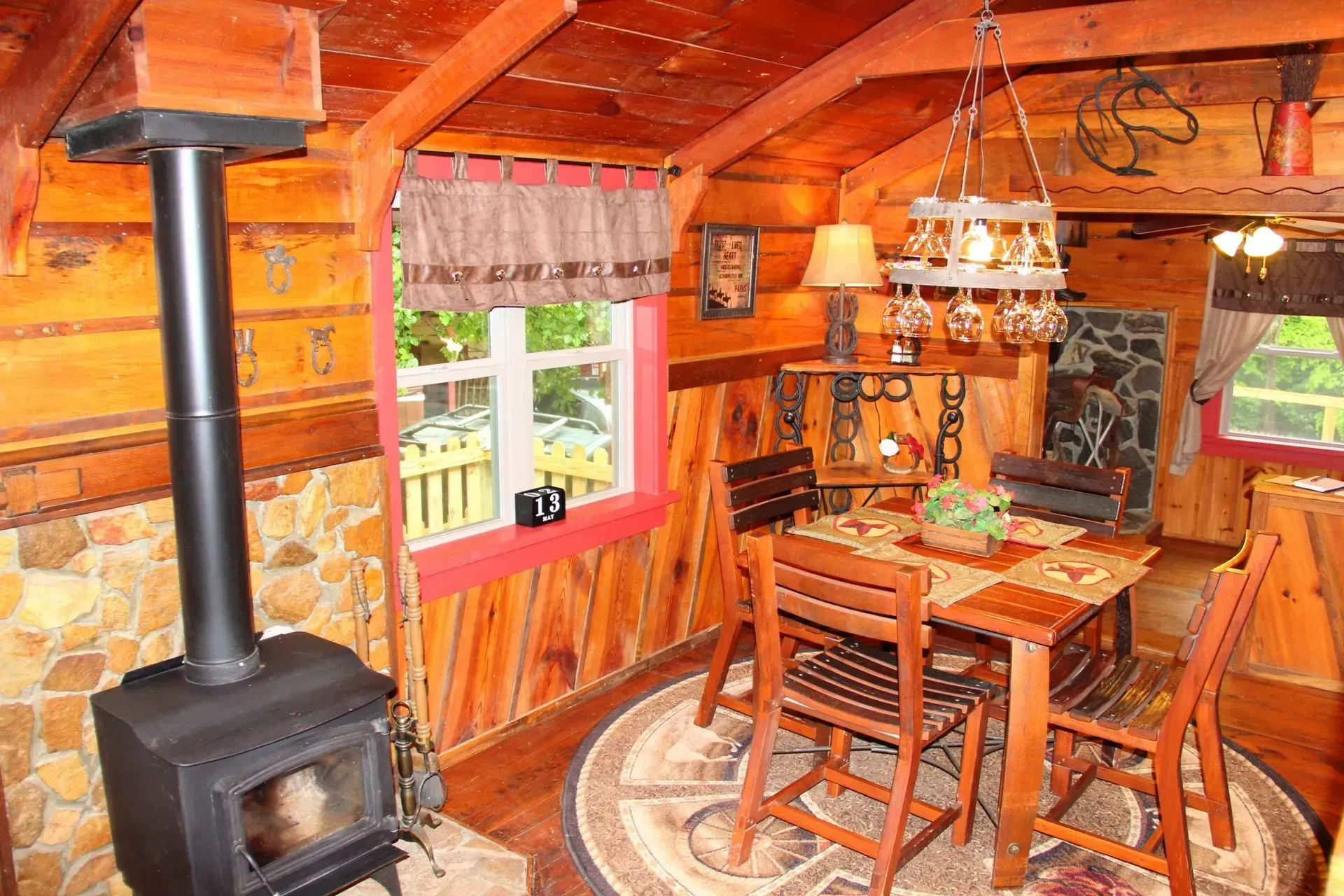 Cozy rustic cabin dining area with stove.