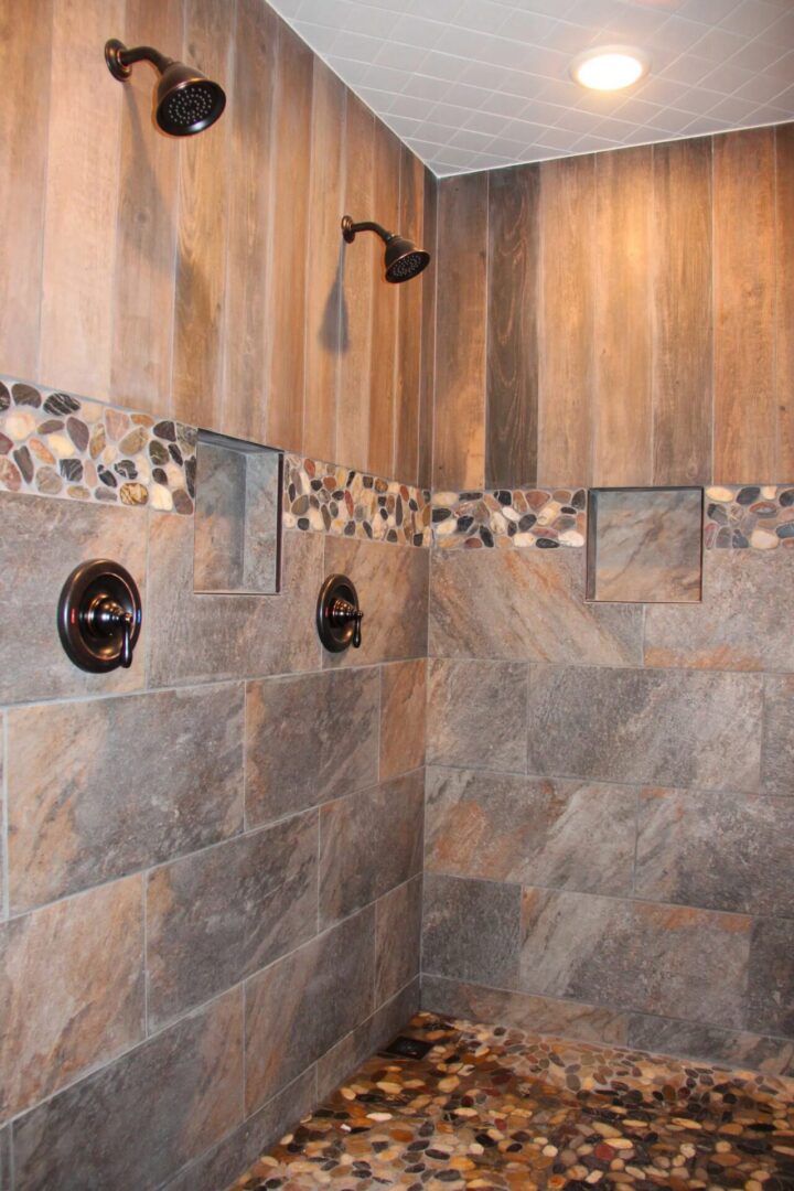 Rustic stone and wood-tiled shower interior.