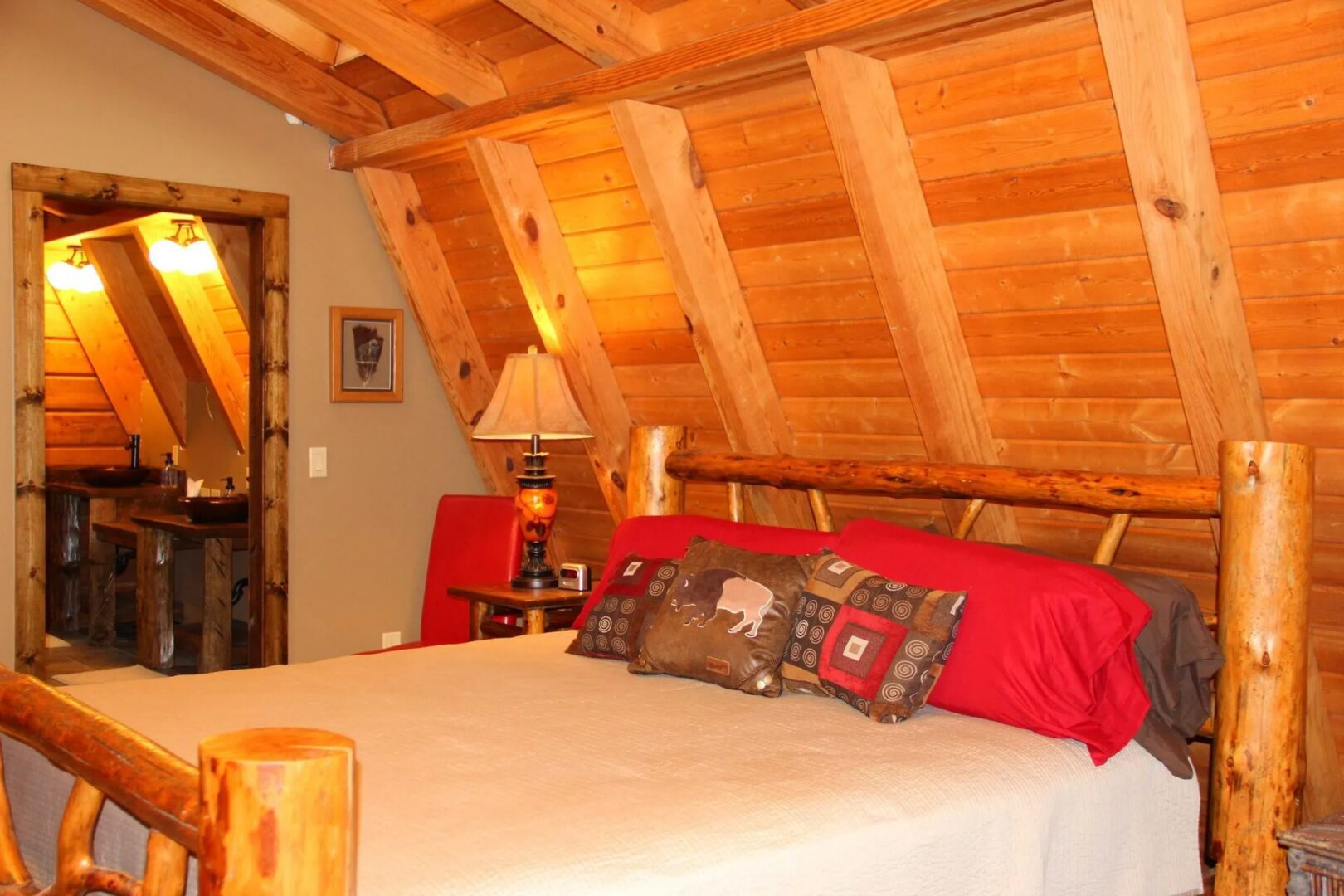 Cozy wooden cabin bedroom with rustic decor.