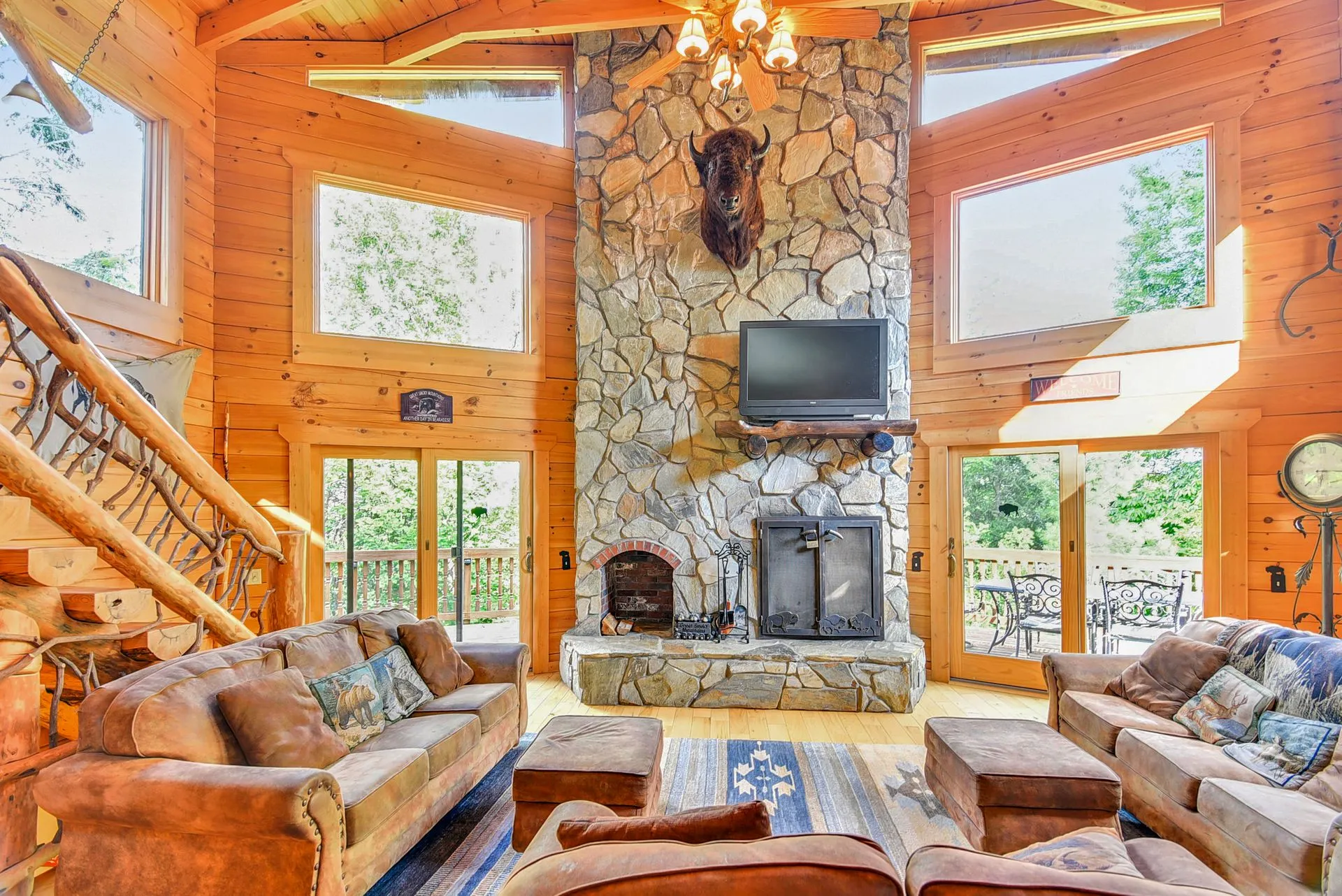 Rustic cabin living room with stone fireplace.