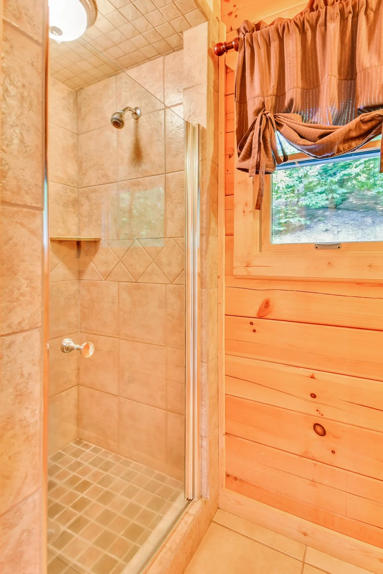 Tile shower with wooden wall and window.
