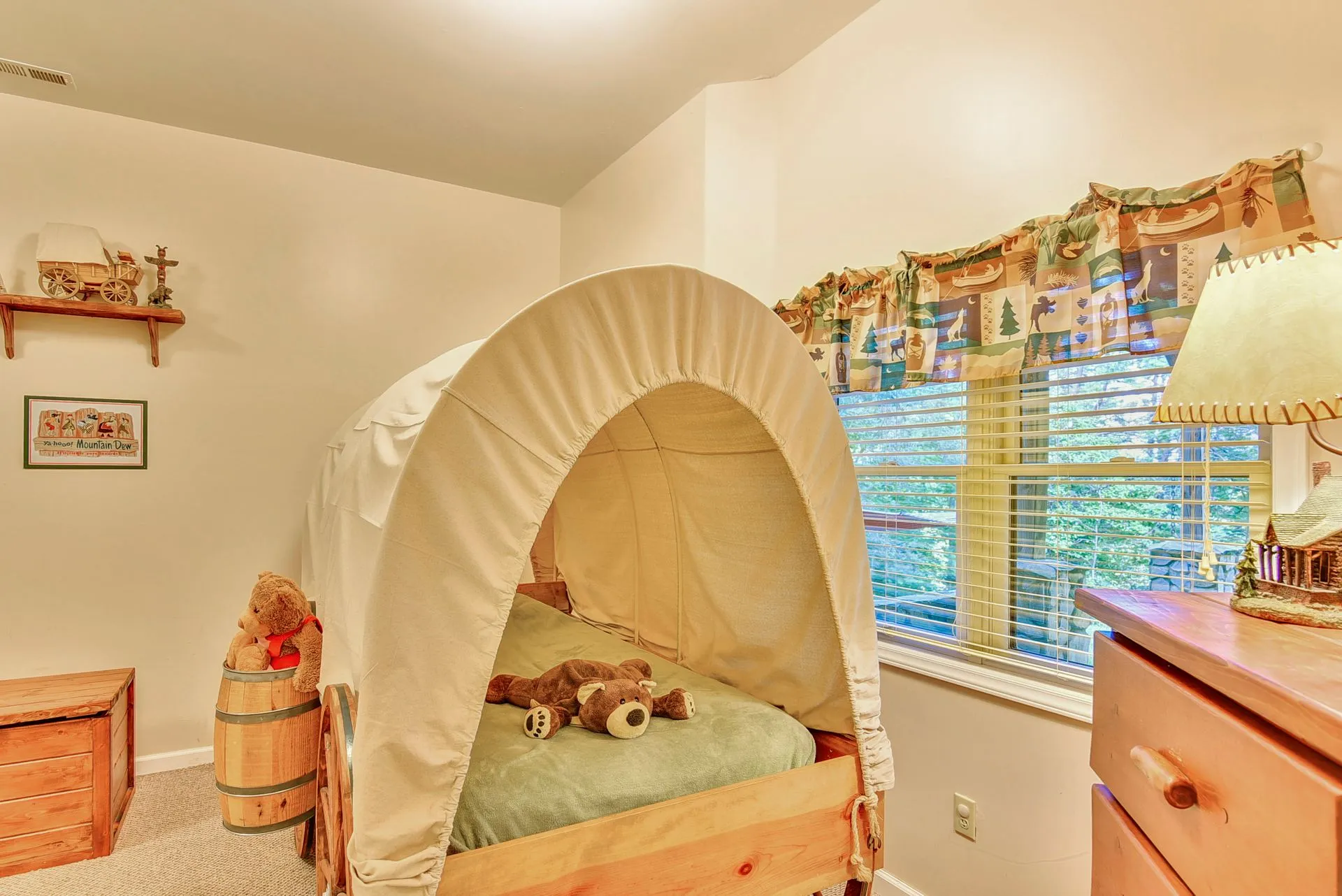 Children's room with wagon-style bed.