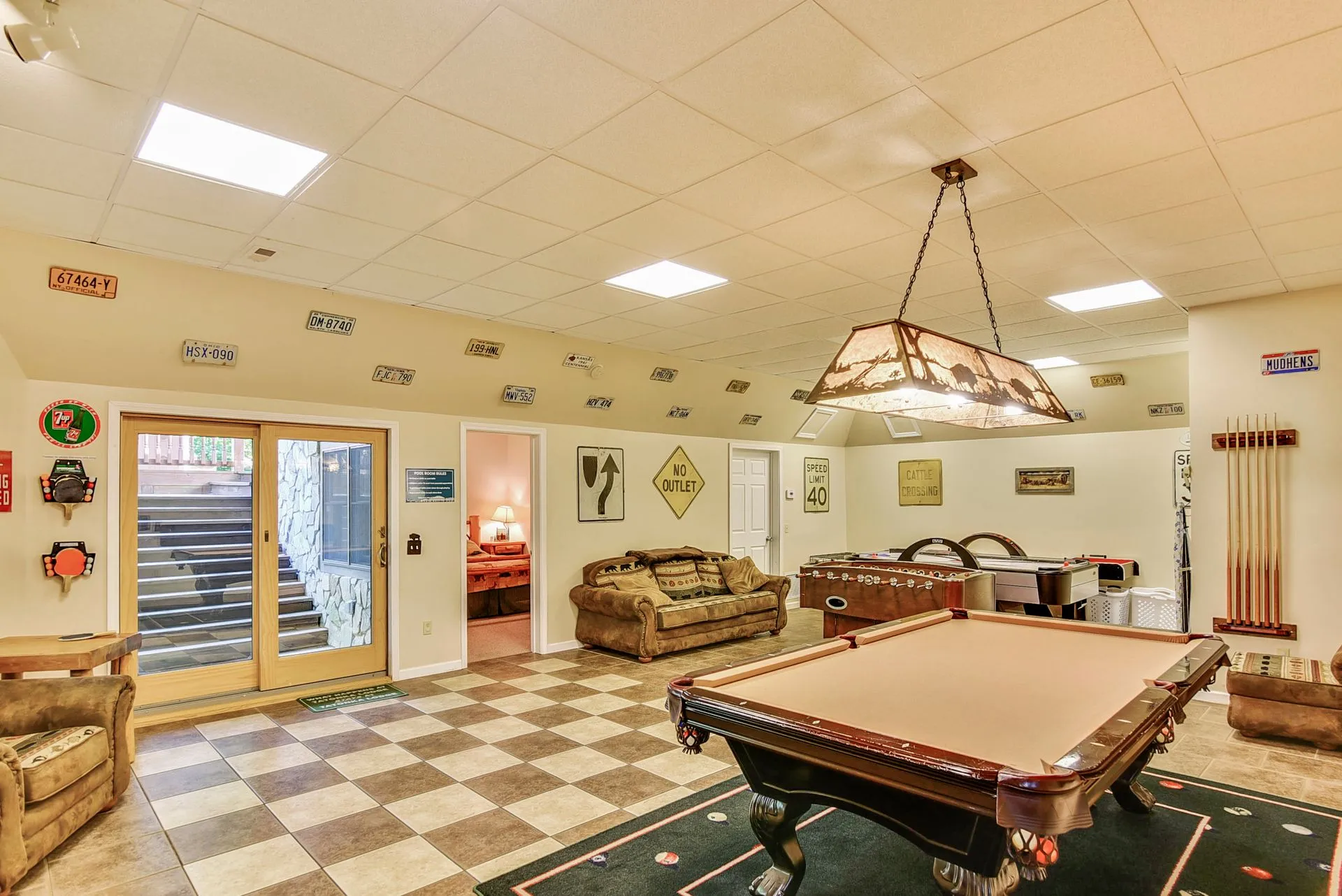Game room with pool table and couches.