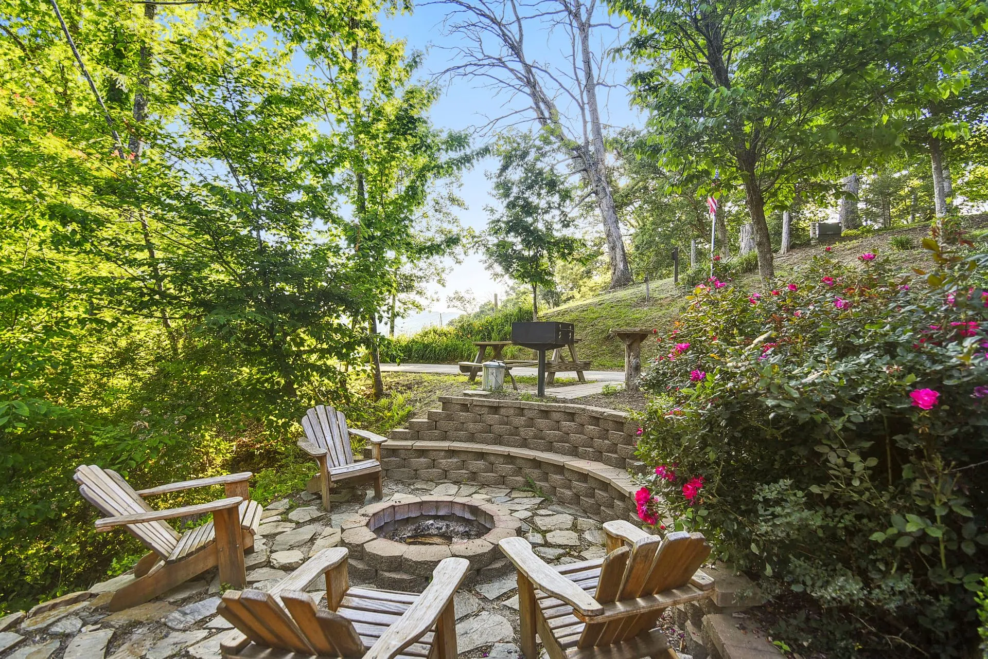 Outdoor patio with chairs and fire pit.