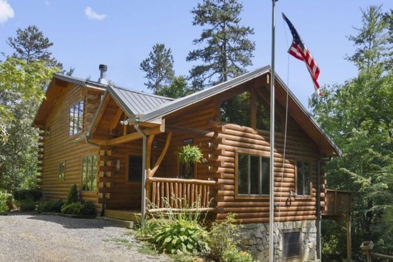 Log cabin with American flag outside.
